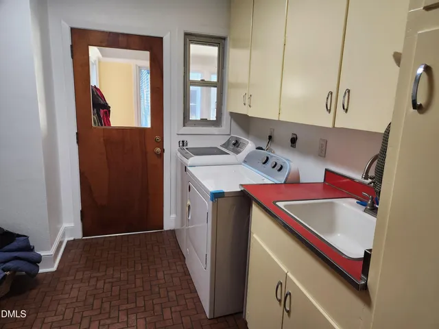 a kitchen with a sink and a refrigerator