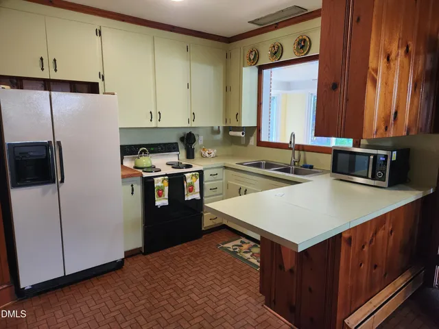 a kitchen with a sink a stove and refrigerator