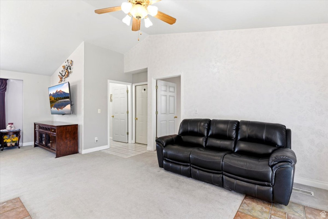 72 Canal Bank Road Garland, UT 84312 - Photo 8 of 40 Vaulted ceilings with a ceiling fan light fixture, light-toned wall finishes, light-toned carpet flooring, and white baseboards