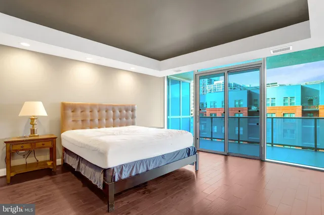 a spacious bedroom with a bed and a large window