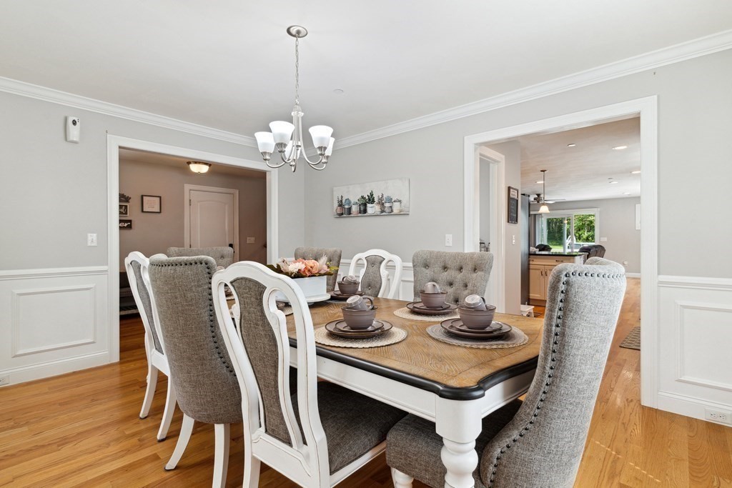 54 Lane Road Derry, NH 03038 - Photo 13 of 34 a view of a dining room with furniture and wooden floor