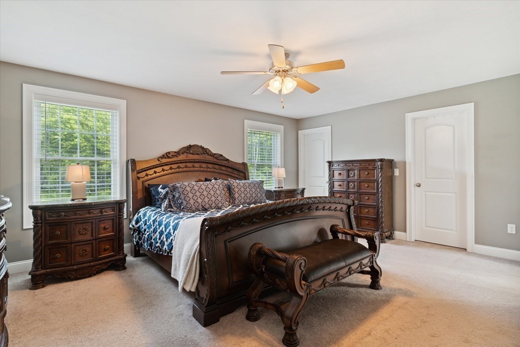 54 Lane Road Derry, NH 03038 - Photo 17 of 34 a bedroom with a bed and a chandelier
