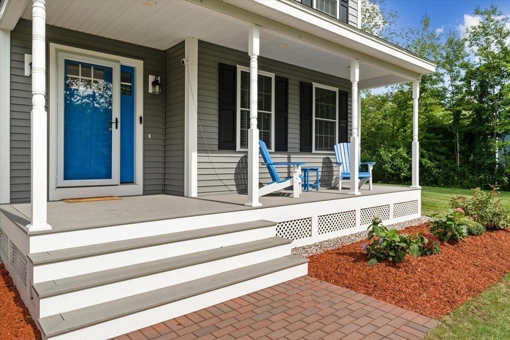 54 Lane Road Derry, NH 03038 - Photo 2 of 34 a view of a house with potted plants and a bench