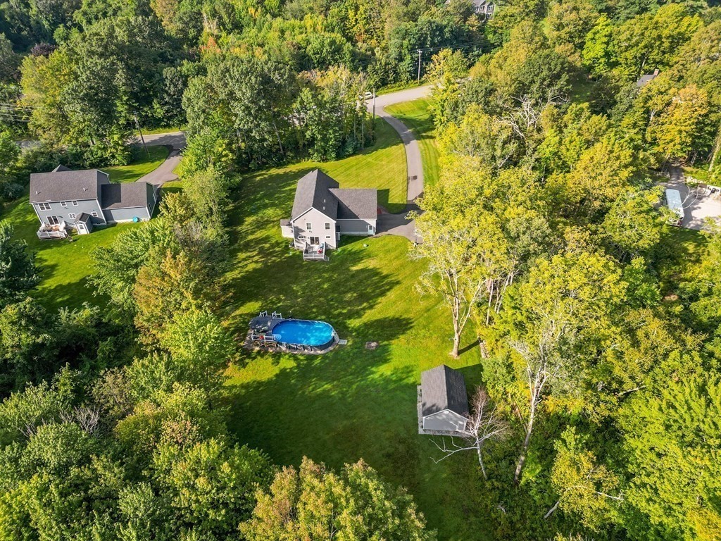 54 Lane Road Derry, NH 03038 - Photo 26 of 34 a backyard of a house with lots of green space and garden