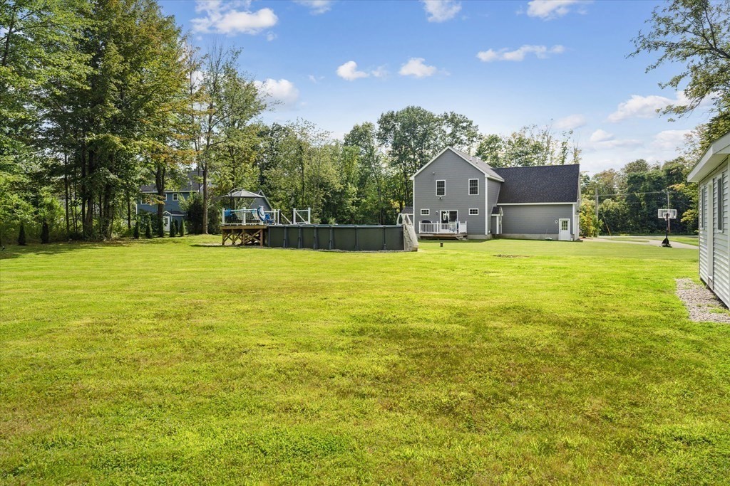 54 Lane Road Derry, NH 03038 - Photo 29 of 34 a view of a house with a big yard and large trees