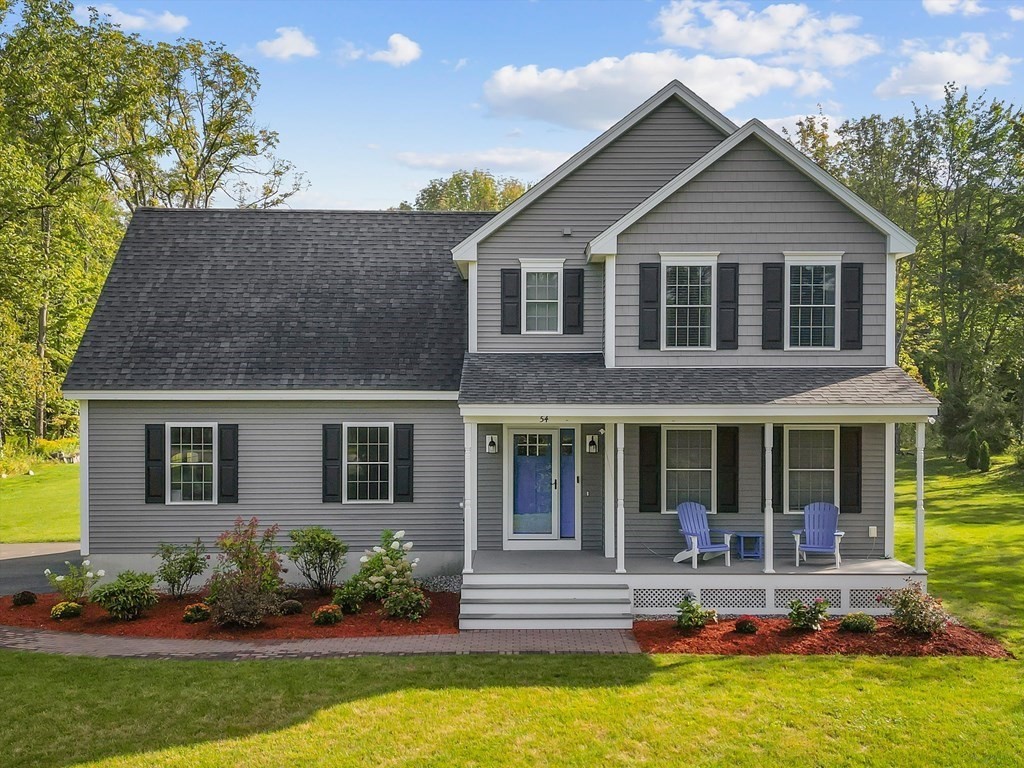 54 Lane Road Derry, NH 03038 - Photo 34 of 34 a front view of a house with a yard table and chairs