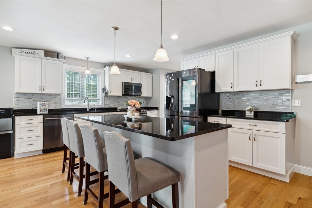54 Lane Road Derry, NH 03038 - Photo 4 of 34 a kitchen with stainless steel appliances granite countertop a stove top oven a refrigerator a sink and dishwasher