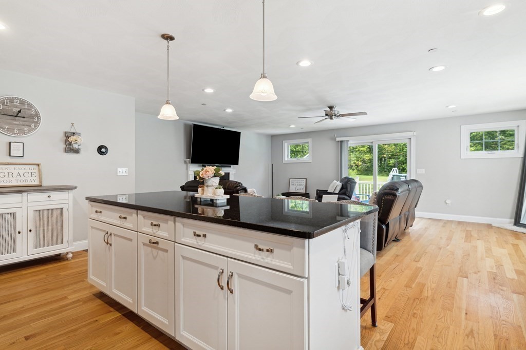 54 Lane Road Derry, NH 03038 - Photo 5 of 34 a kitchen with stainless steel appliances granite countertop a sink a stove and a wooden floors