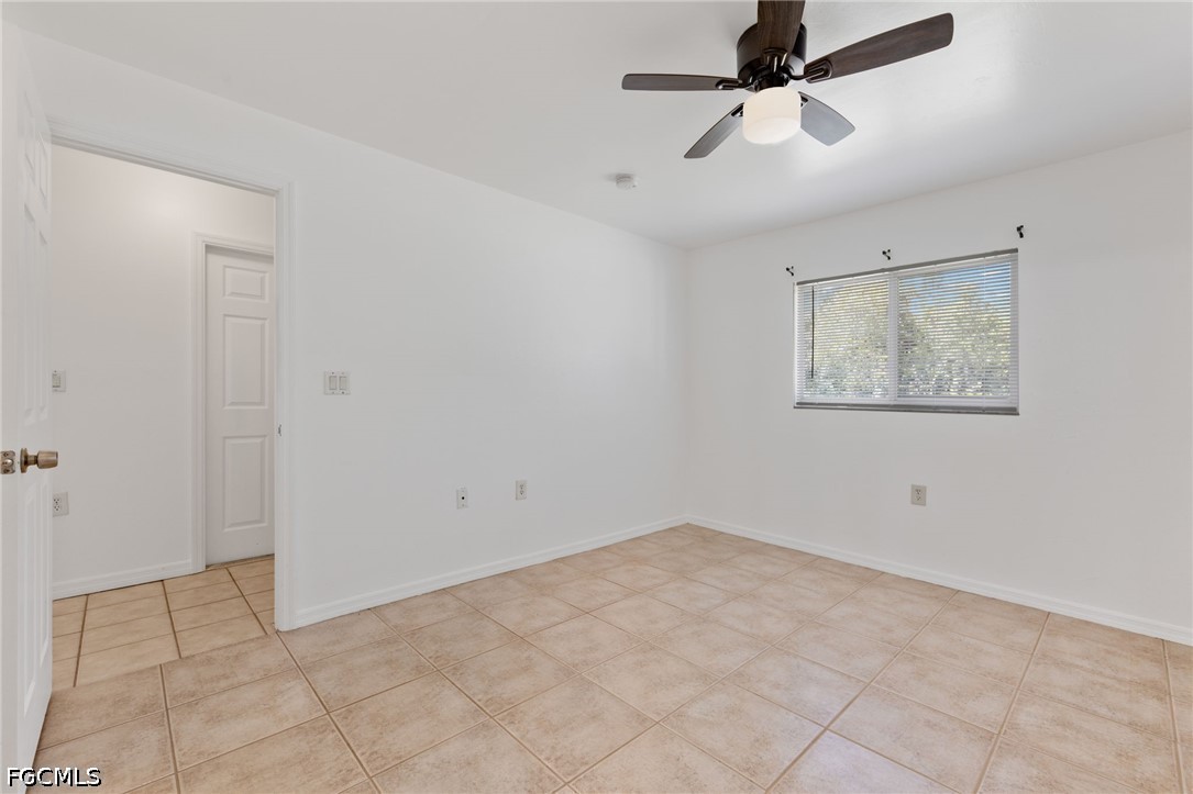 221 Meadow Road Lehigh Acres, FL 33973 - Photo 7 of 13 wooden floor in an empty room