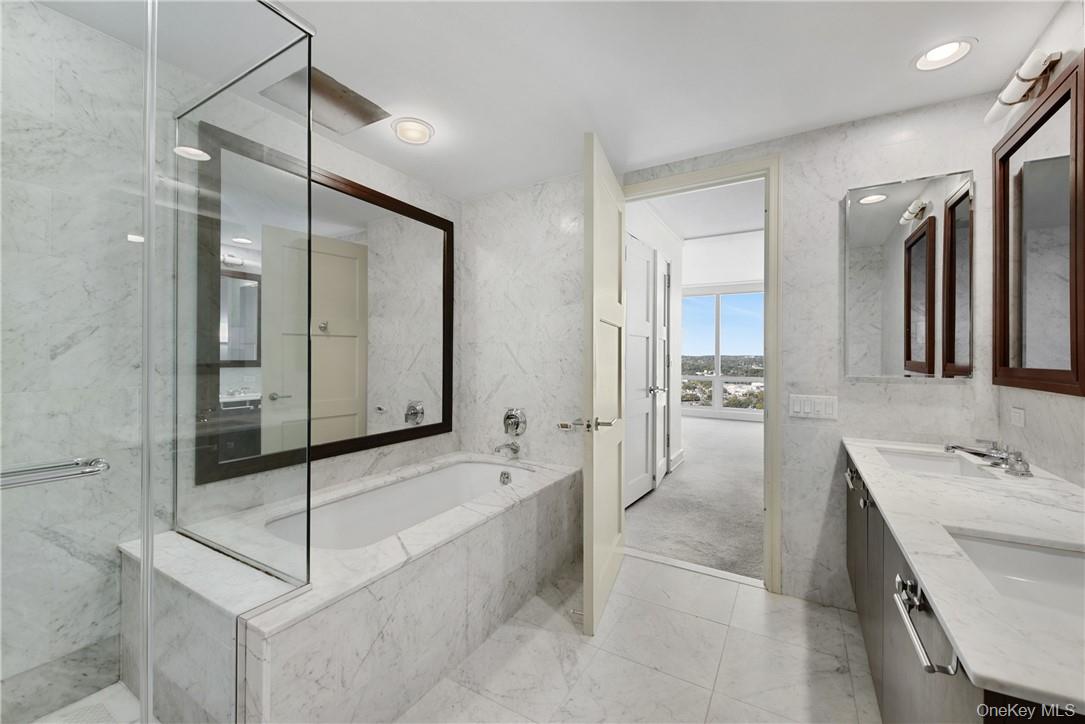 1 Renaissance Square, Unit V4G White Plains, NY 10601 - Photo 12 of 17 a bathroom with a tub shower and sink