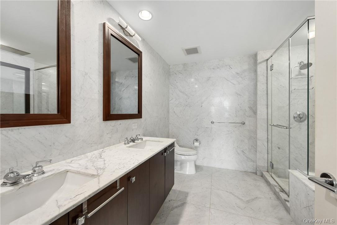 1 Renaissance Square, Unit V4G White Plains, NY 10601 - Photo 13 of 17 a bathroom with a double vanity sink mirror and toilet