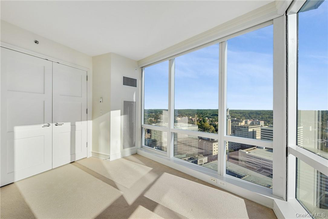 1 Renaissance Square, Unit V4G White Plains, NY 10601 - Photo 15 of 17 a room with a bed and a large window