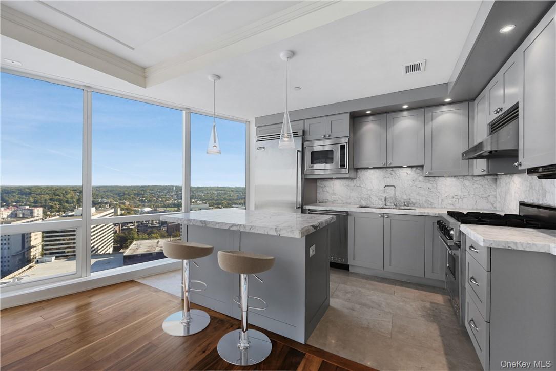 1 Renaissance Square, Unit V4G White Plains, NY 10601 - Photo 2 of 17 a kitchen with a sink appliances and cabinets