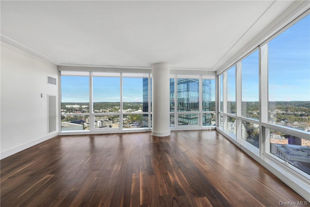 1 Renaissance Square, Unit V4G White Plains, NY 10601 - Photo 6 of 17 wooden floor in an empty room with a large window