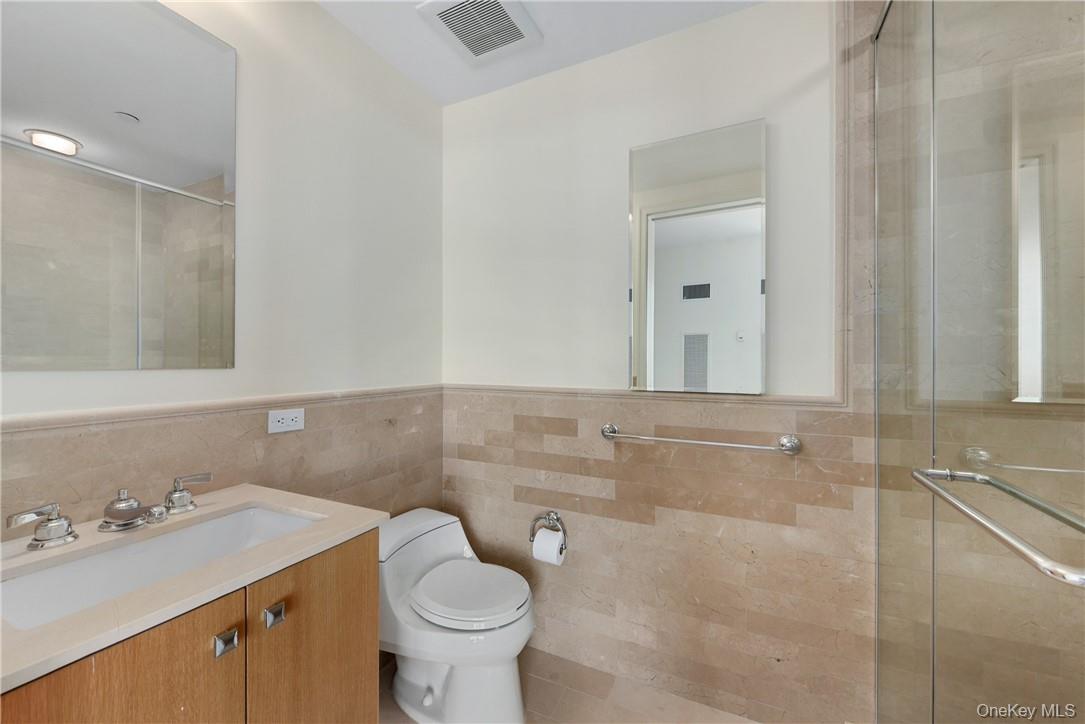1 Renaissance Square, Unit V4G White Plains, NY 10601 - Photo 10 of 17 a bathroom with a sink toilet and vanity