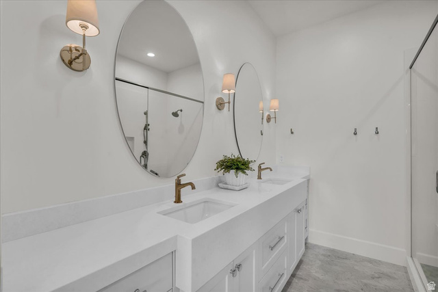 2608 Canyon Ridge Drive St. George, UT 84770 - Photo 64 of 86 Double vanity featuring white shaker cabinetry, white countertops, and dual oval mirrors