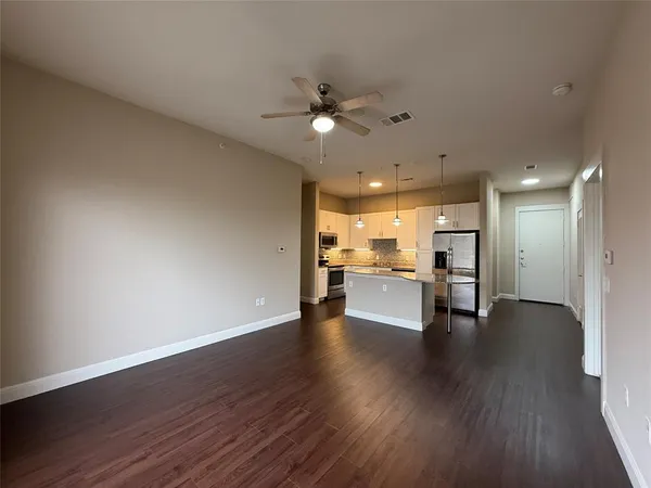 a view of a kitchen with wooden floor and a kitchen