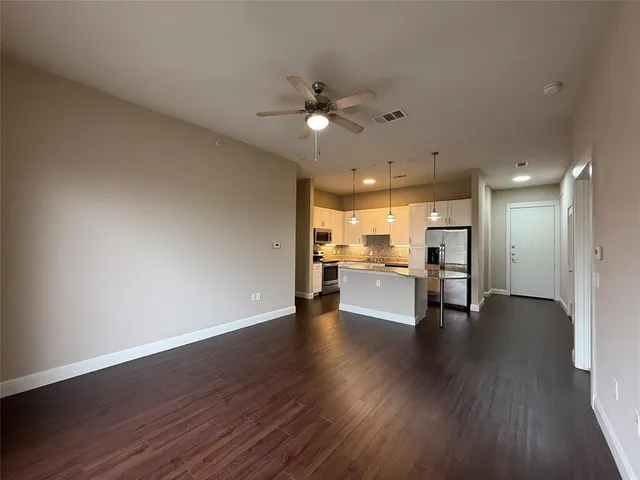 a view of a kitchen with wooden floor and a kitchen