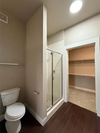 a bathroom with a toilet and a shower