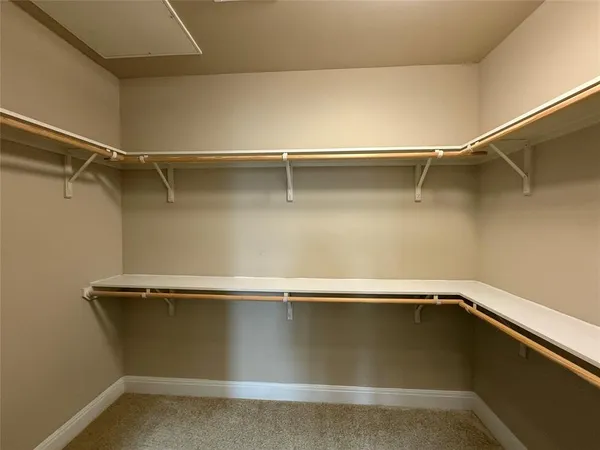 a bathroom with a double vanity sink and a toilet