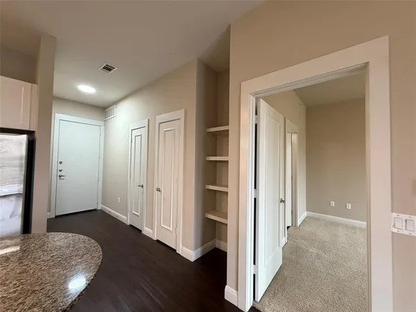 a spacious bathroom with a granite countertop sink mirror and a toilet