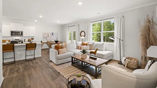 a living room with furniture and a wooden floor