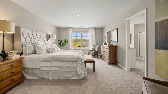 a spacious bathroom with a double vanity sink a mirror a bathtub and next to a window
