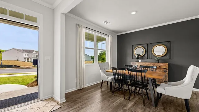 a view of a dining room with furniture and a large window