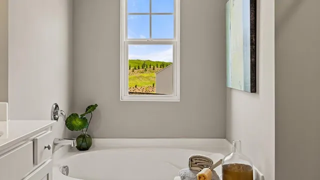 a bedroom with a bed and a mirror on the dresser