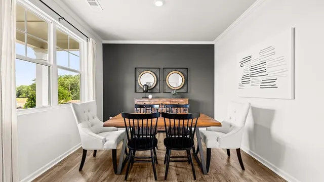 a dining room with furniture and window