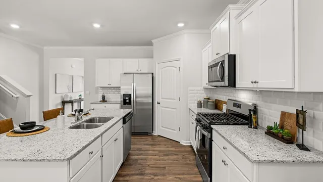 a kitchen with a refrigerator and a stove top oven