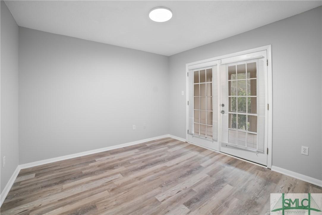 401 North Cromwell Road, Unit T7 Savannah, GA 31410 - Photo 16 of 41 Primary Bedroom with french doors to the screened