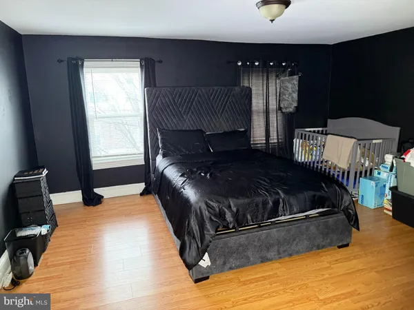 a bedroom with a bed window and a night stand