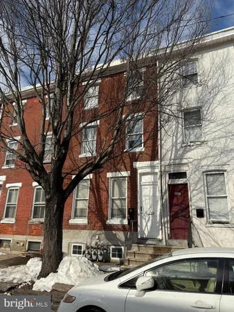 a view of a building with a large tree