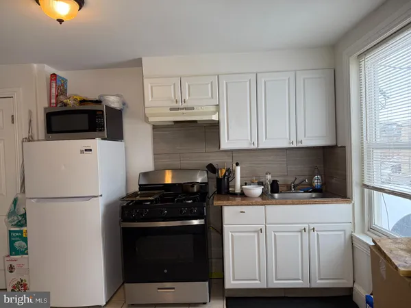 a kitchen with stainless steel appliances a refrigerator sink and cabinets