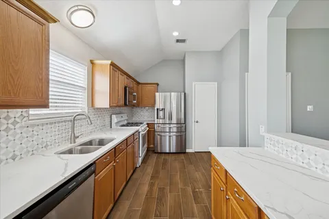 a kitchen with a sink stove and refrigerator