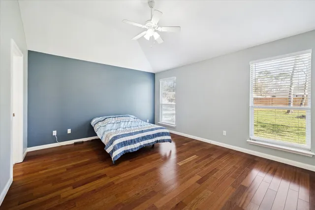 a living room with hard wood floors and a window