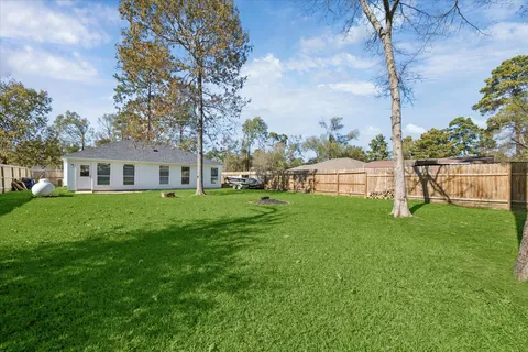 a front view of house with a garden