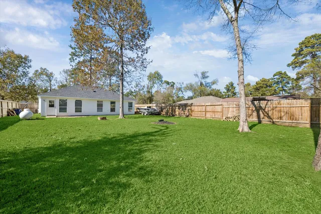 a front view of house with a garden