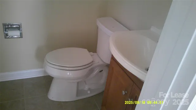 a white toilet sitting next to a sink