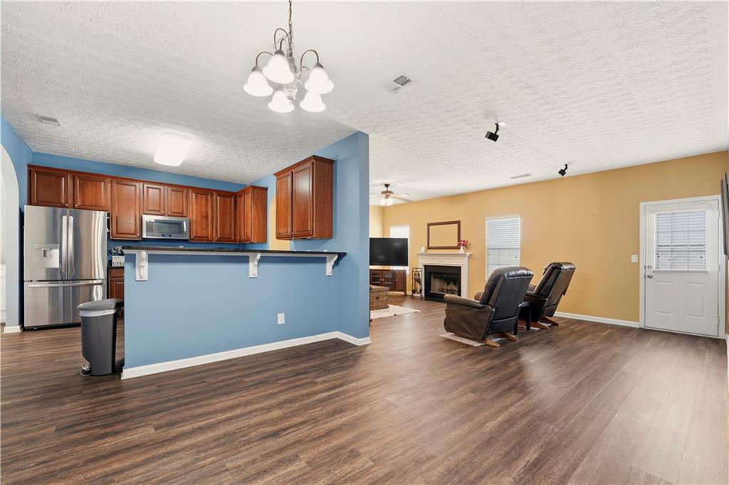 2708 Oakmont Way Monroe, GA 30656 - Photo 11 of 40 a living room with furniture and a wooden floor