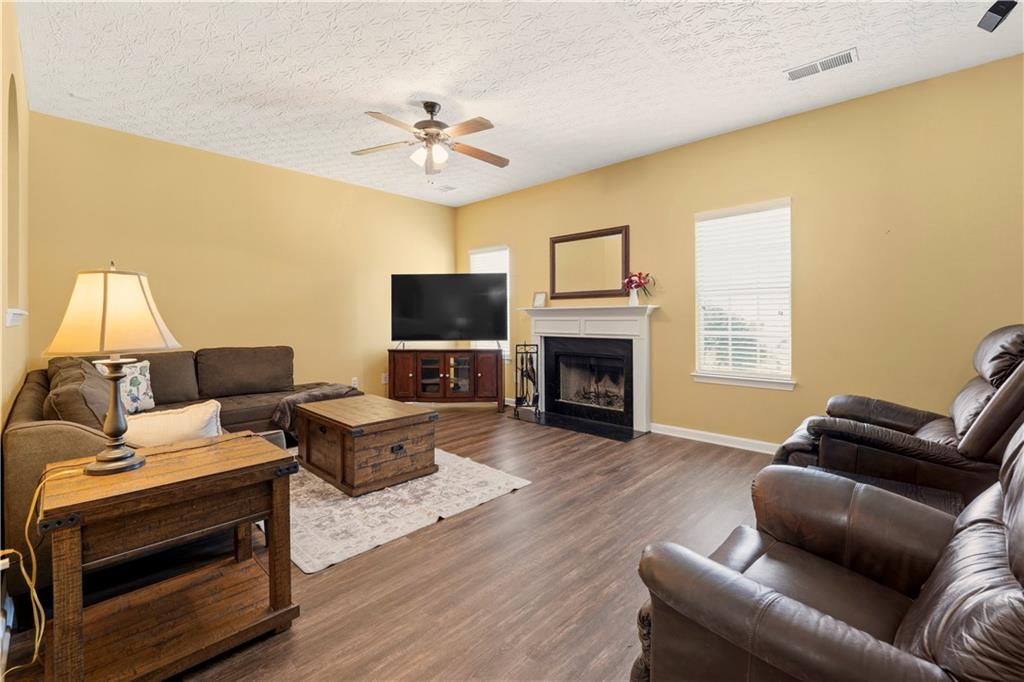 2708 Oakmont Way Monroe, GA 30656 - Photo 12 of 40 a living room with furniture and a fireplace