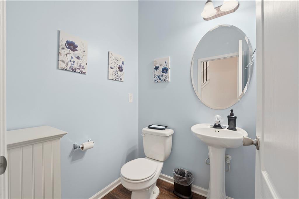 2708 Oakmont Way Monroe, GA 30656 - Photo 13 of 40 a bathroom with a toilet a sink and mirror