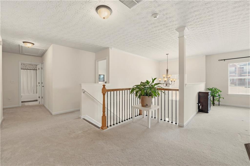 2708 Oakmont Way Monroe, GA 30656 - Photo 19 of 40 an empty room with stairs and a window