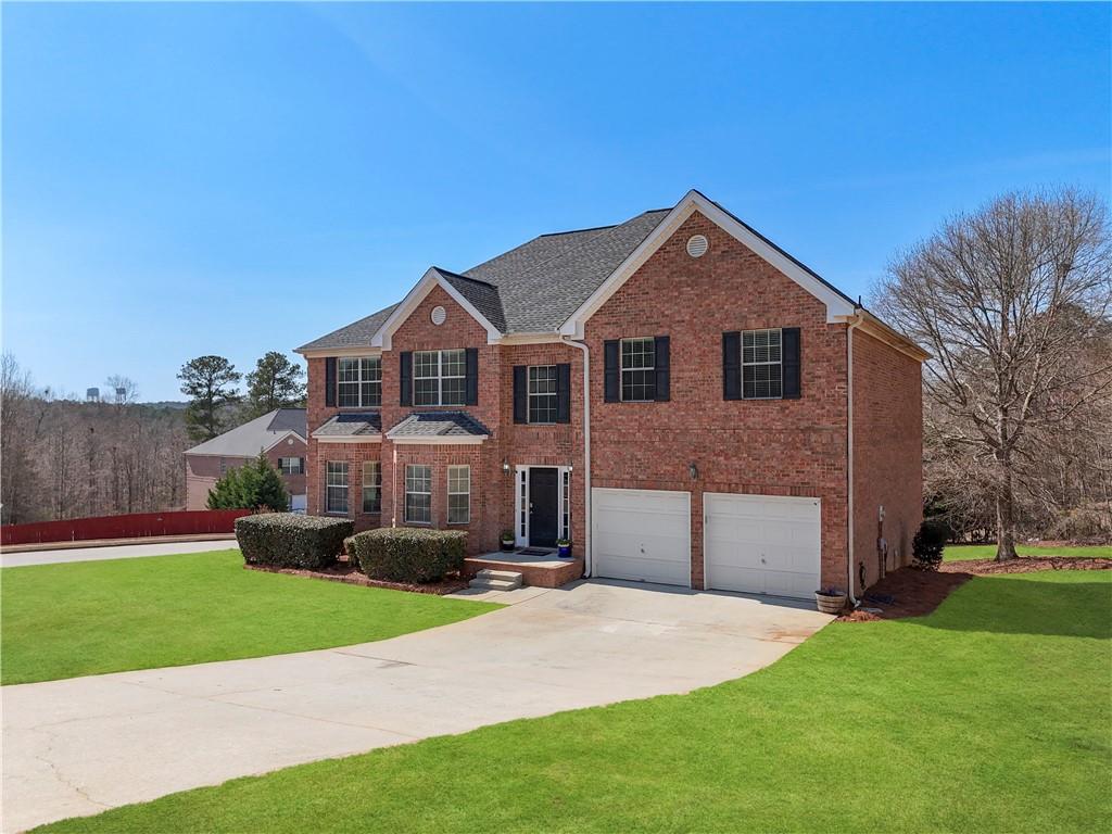 2708 Oakmont Way Monroe, GA 30656 - Photo 2 of 40 a front view of a house with a yard and garage