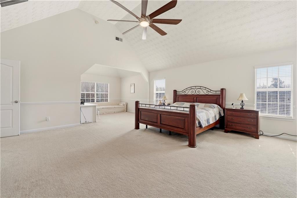 2708 Oakmont Way Monroe, GA 30656 - Photo 21 of 40 a spacious bedroom with a bed and a window