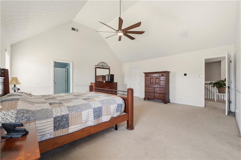 2708 Oakmont Way Monroe, GA 30656 - Photo 22 of 40 a bed room with a bed and a chandelier