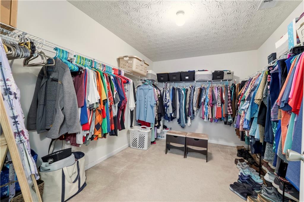 2708 Oakmont Way Monroe, GA 30656 - Photo 26 of 40 a view of walk in closet with clothes