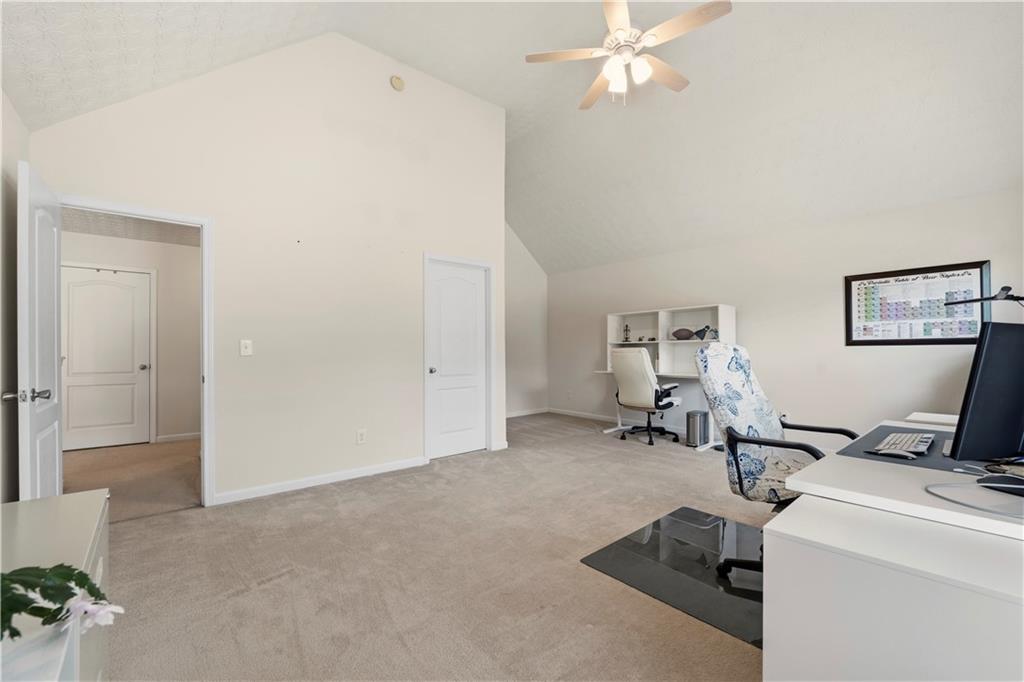 2708 Oakmont Way Monroe, GA 30656 - Photo 27 of 40 a view of a workspace with furniture and a chandelier fan