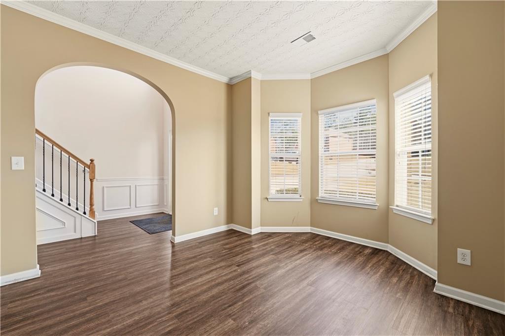 2708 Oakmont Way Monroe, GA 30656 - Photo 5 of 40 an empty room with wooden floor and windows